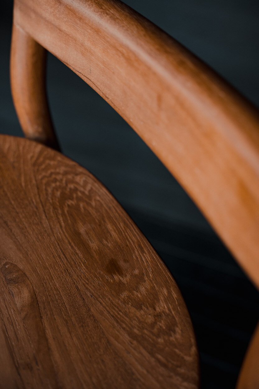 Close-up of a sculpted solid teak curve, crafted by Baroba