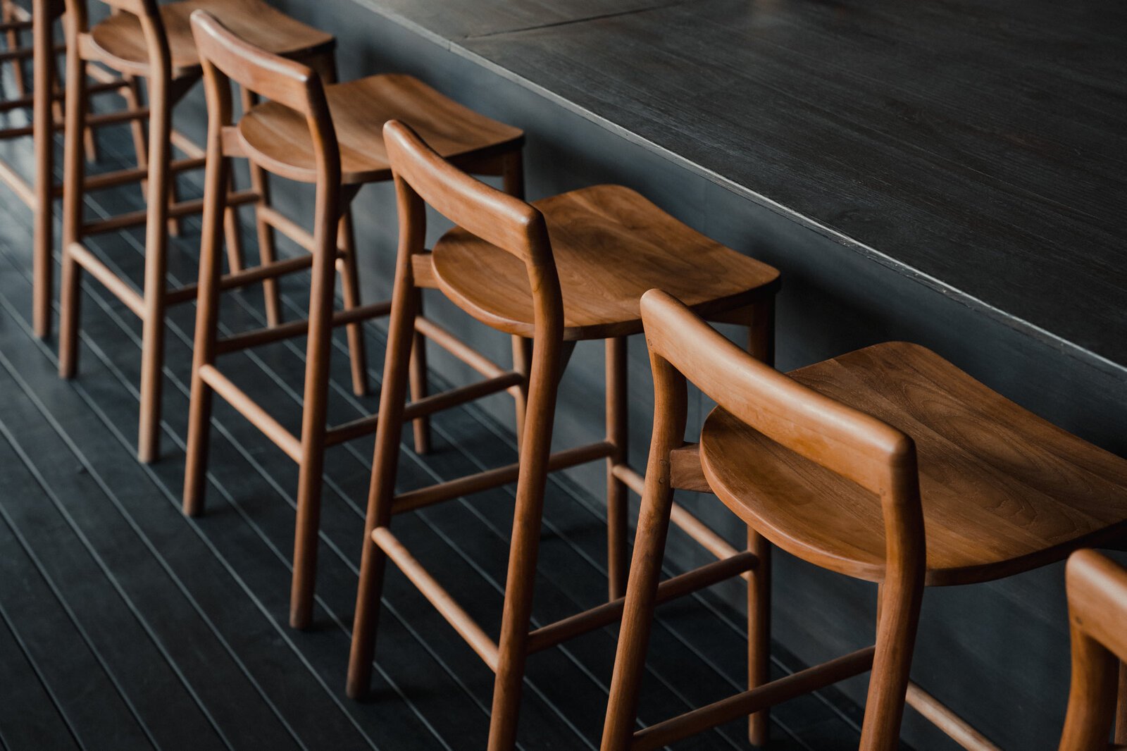 Baroba teak bar stools installed at a hospitality venue